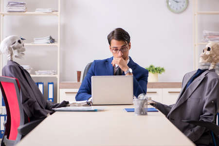 Funny business meeting with boss and skeletonsの写真素材