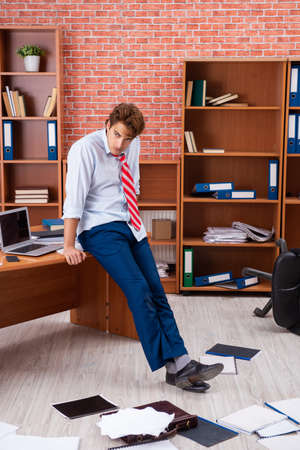 Unhappy businessman sitting in the officeの写真素材