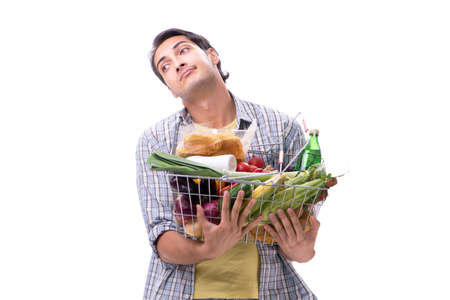 Young man with his grocery shopping on whiteの写真素材