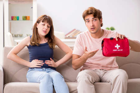 Young family getting treatment with first aid kitの写真素材