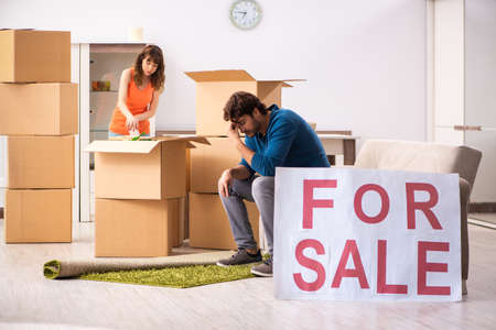Young family offering house for sale and moving outの写真素材