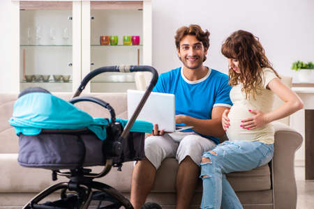 Young parents with baby expecting new arrival