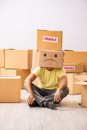 Unhappy man with box instead of his headの写真素材