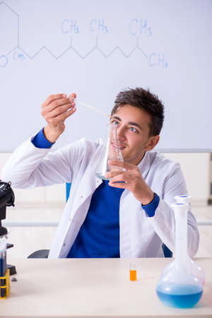 Young chemist sitting in the labの写真素材