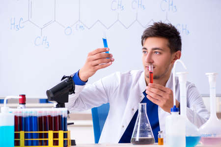 Young chemist sitting in the lab