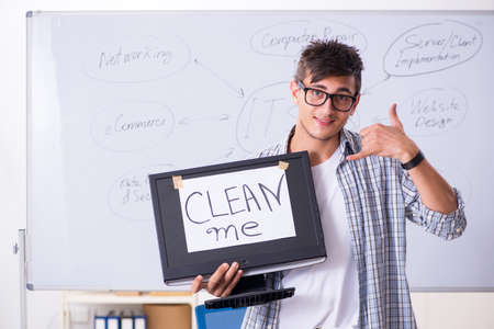 Young it specialist in front of the whiteboardの写真素材