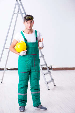 Young worker with protective equipment in safety conceptの写真素材