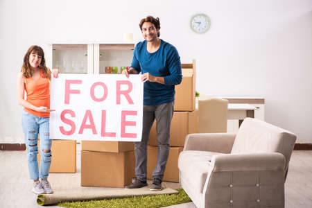 Young family offering house for sale and moving outの写真素材