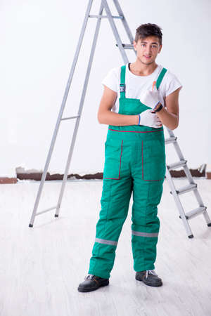 Young contractor in house renovation conceptの写真素材