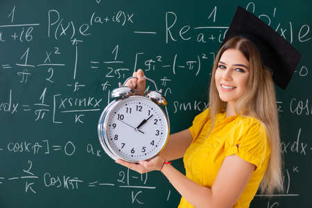 Young female student in front of the chalkboard