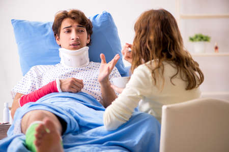 Loving wife looking after injured husband in hospitalの写真素材