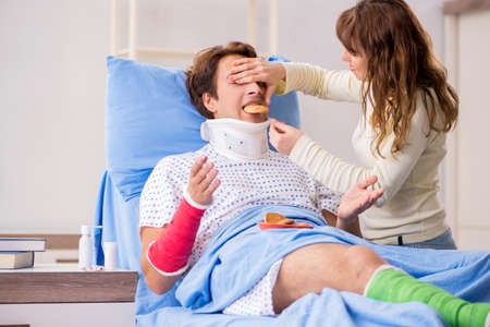 Loving wife looking after injured husband in hospital