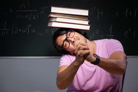 Young male student sitting in classroom