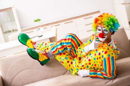 Male clown preparing for perfomance at home