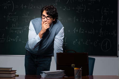 Young math teacher in front of chalkboard
