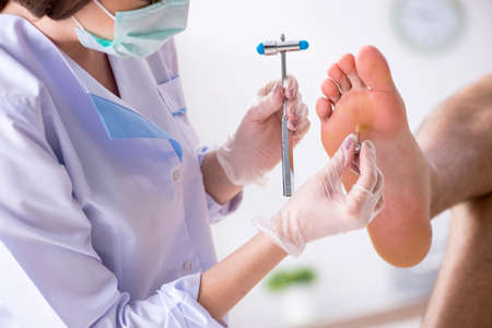 Podiatrist treating feet during procedure