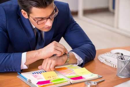 Young handsome employee planning his work activityの写真素材