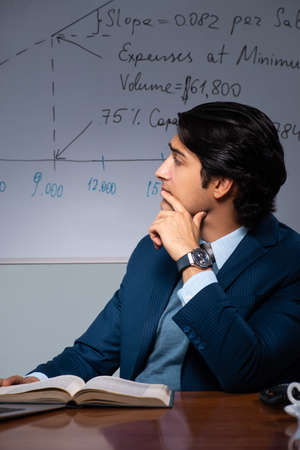 Financial specialist working late in the officeの写真素材