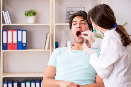 Doctor getting saliva test sample in clinic hospital