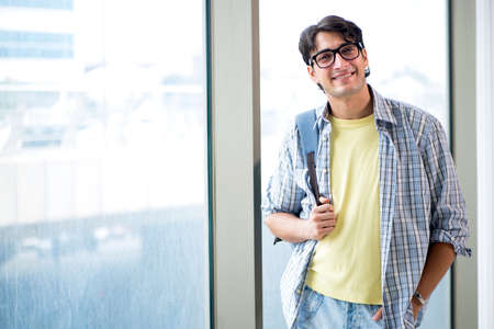 Young handsome student standing at the window