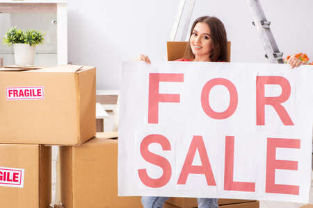 Young beautiful woman selling flatの写真素材