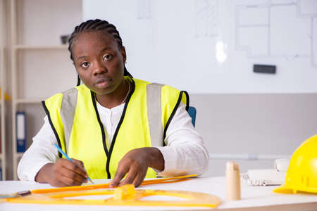Young black architect working on project