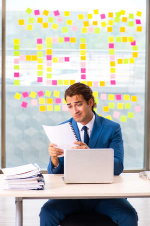 Busy businessman working in the officeの写真素材