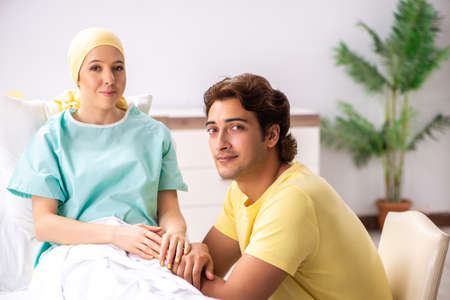 Husband looking after wife in hospitalの写真素材