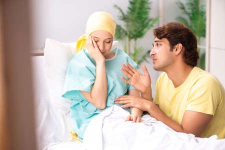 Husband looking after wife in hospitalの写真素材