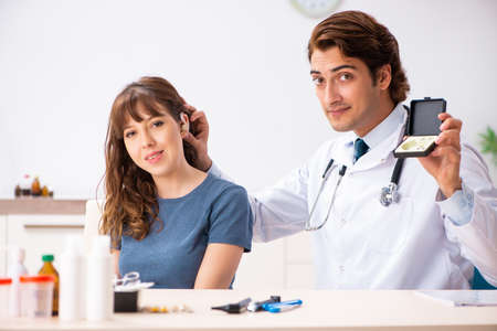 Patient with hearing problem visiting doctor otorhinolaryngologiの写真素材
