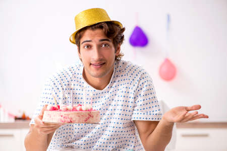 Young man celebrating his birthday in hospitalの写真素材