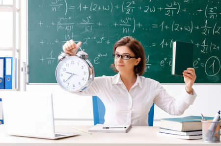 Female math teacher in front of the chalkboardの写真素材