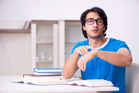 Young handsome student studying at homeの写真素材