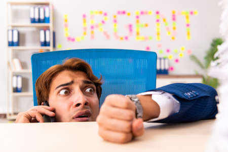 Young employee suffering from excessive workの写真素材