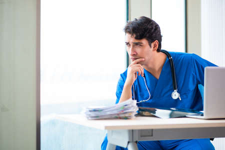 Young handsome doctor working in the hospitalの写真素材
