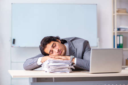 Young handsome businessman employee in the officeの写真素材