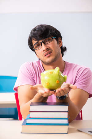 Young male student sitting in the classの写真素材