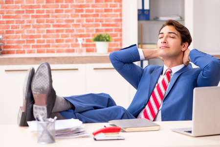 Young handsome employee working in the officeの写真素材