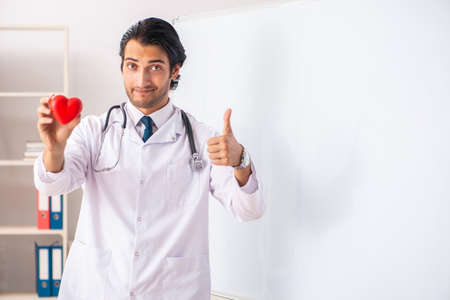 Young doctor in front of whiteboardの写真素材