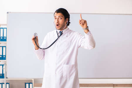 Young doctor in front of whiteboardの写真素材