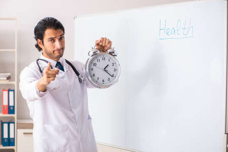 Young doctor in front of whiteboardの写真素材