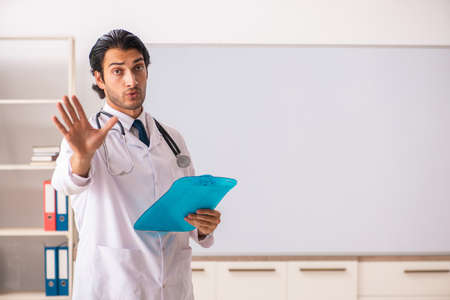 Young doctor in front of whiteboardの写真素材