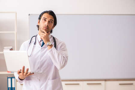 Young doctor in front of whiteboardの写真素材