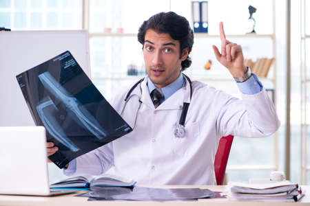 Young handsome male radiologist in front of whiteboardの写真素材