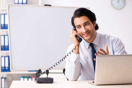 Young handsome financial speciaist in front of white boardの写真素材
