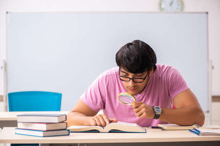 Young male student sitting in the classの写真素材