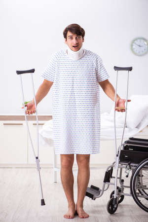 Young handsome man in wheelchair at the hospitalの写真素材