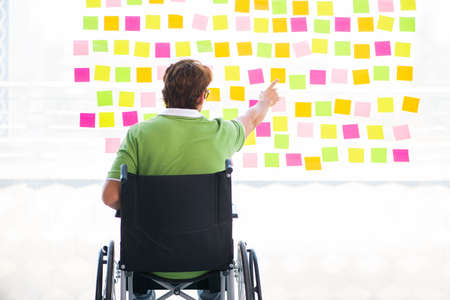 Young student in wheelchair with many conflicting prioritiesの写真素材