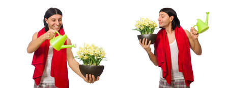 Young man watering flowers isolated on whiteの写真素材