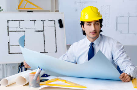 Young handsome architect working on the project
